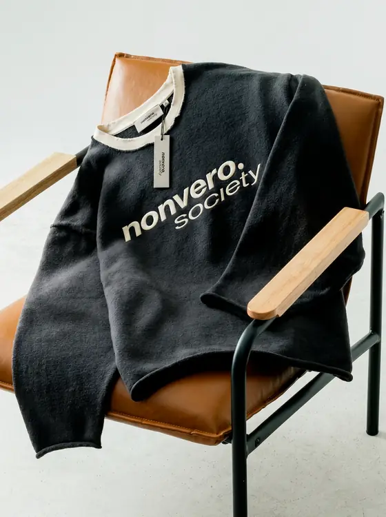 A Nonvero Society sweatshirt on a chair
