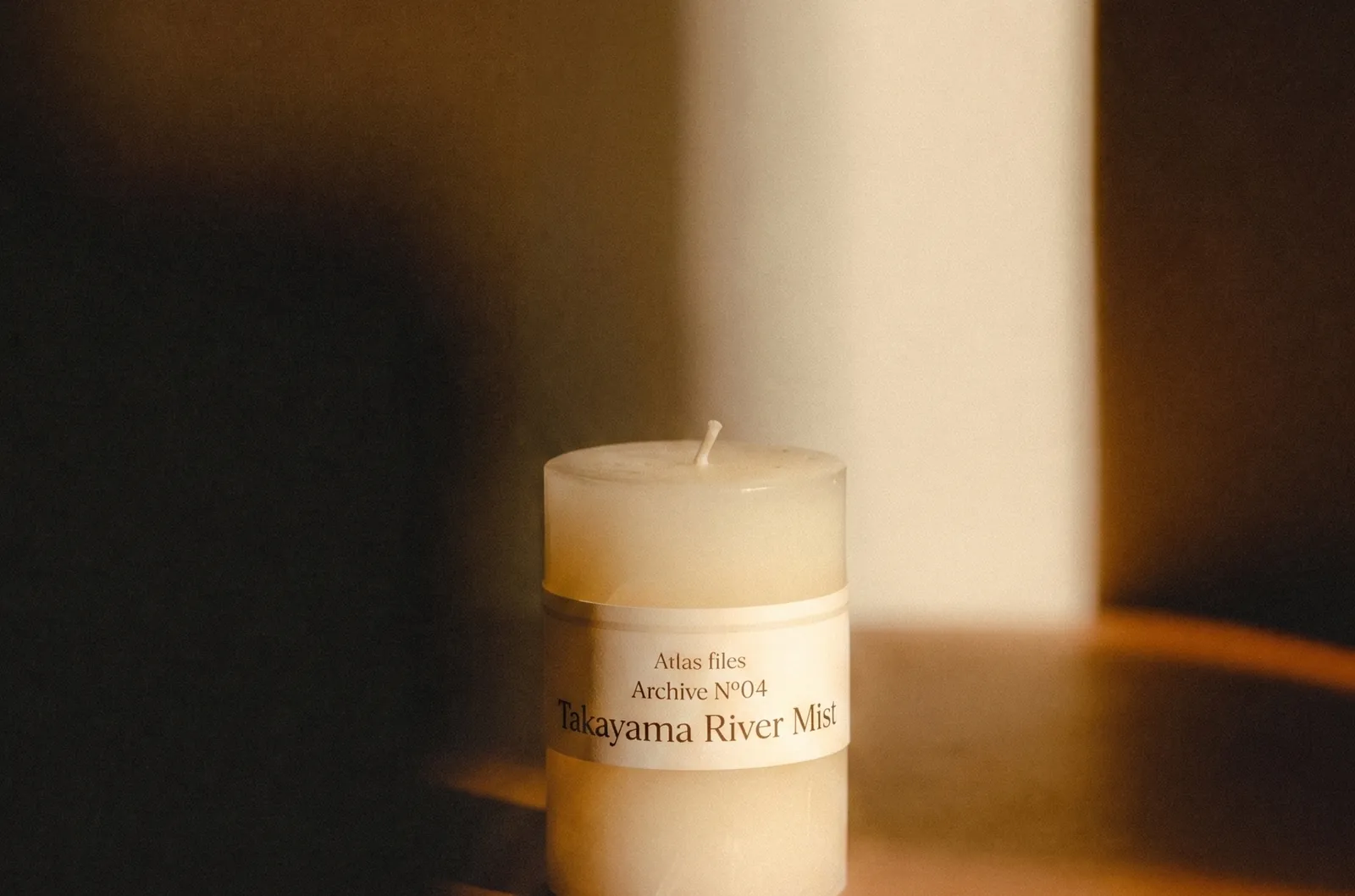 Atlas Files — the candle on a side table